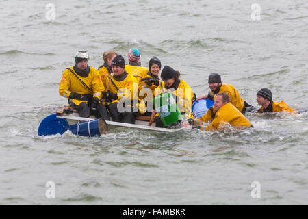 Poole, Dorset, UK. 1st January, 2016. Hundreds turn out to watch the New Years Day Bath Tub Race. A variety of unusual craft take to the water to race between the steps of The Customs House and the steps of The Lord Nelson and The Jolly Sailor, having fun throwing eggs and flour, firing water cannons and capsizing competing craft. Credit:  Carolyn Jenkins/Alamy Live News Stock Photo