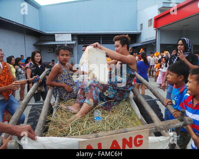 Philippines. 01st Jan, 2016. 'Aguman Sandok Festival' or 'Belles of Minalin' is the annual festival of Minalin, Pampanga where men cross-dress and they go dancing in the streets on New Year's Day to give laughter to towns-mates. The festival started in 1932 after the town had experienced extreme drought in 1931: to welcome 1932 with a big bang and to make the people smile after the calamity, a group of men started the new year of 1932 by wearing dress and it became a tradition every year for more than eight decades now. © Sherbien Dacalanio/Pacific Press/Alamy Live News Stock Photo