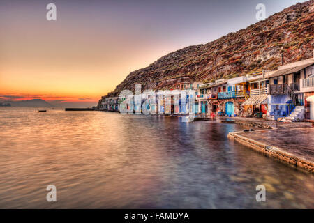 Sunset at the fishermen houses with the impressive boat shelters, also known as “syrmata” in Klima of Milos, Greece Stock Photo