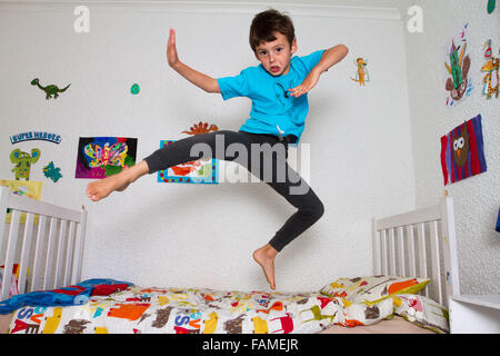 Boy jumping on bed