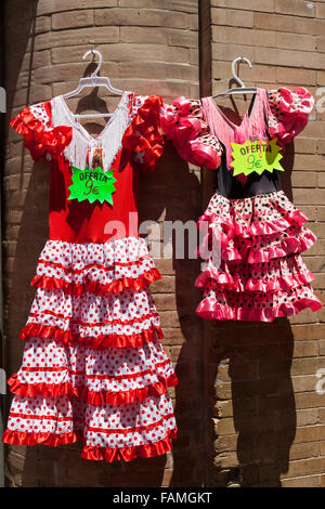Children's flamenco dresses on sale outside a shop, Santa Cruz Barrio, Seville, Andalusia, Spain Stock Photo