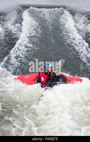 Woman kayaking in fast water Stock Photo