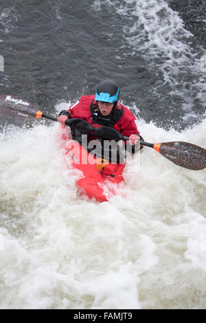 Woman kayaking in fast water Stock Photo