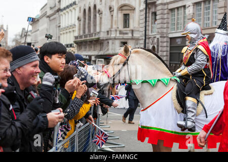 London, UK. 1st January, 2016. A performer from All the Queen's Horses allows spectators to get close to her calm horse at the 30th annual London's New Year's Day Parade, LNYDP 2016. The parade has more than 8,500 performers representing 20 countries world-wide, including marching bands, cheerleaders, clowns, acrobats and representatives of the London Boroughs. Credit:  Imageplotter/Alamy Live News Stock Photo