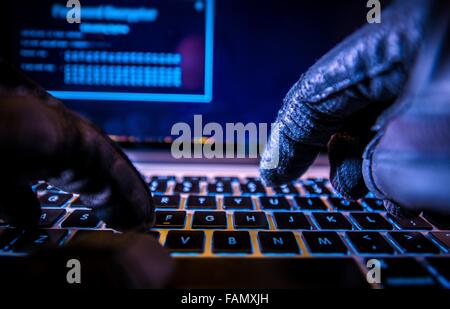 Payments System Hacking. Online Credit Cards Payment Security Concept. Hacker in Black Gloves Hacking the System. Stock Photo