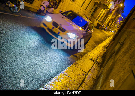 Via Garibaldi at dusk in rain with passing car, Verona Stock Photo - Alamy