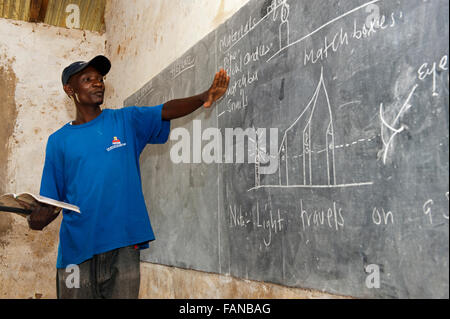 Teacher teaching science on a blackboard in a classroom, Kenya Stock Photo