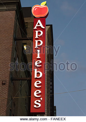 A logo sign outside of a Applebee&#039;s restaurant location in Fredericksburg, Virginia on February