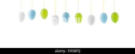 colorful hanging easter eggs in a row isolated over white background Stock Photo