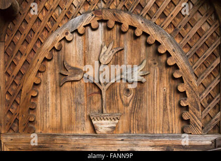 Beautiful traditional ornament in form of tulips from a hand made door from the entrance in a Romanian household Stock Photo