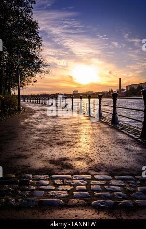 Sunsetting over Belfast from the cobbled paths of the River Lagan towpath Stock Photo