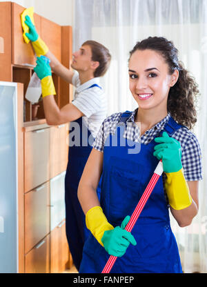 Positive professional cleaners team at the work in ordinary office Stock Photo