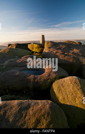 The trig point located at the southern end of Stanage Edge in the Peak District National Park on a cold wintry morning. Stock Photo