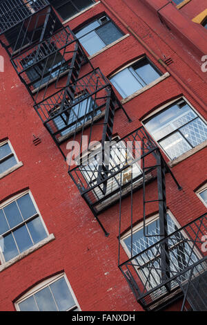 Fire escape ladders on a red brick building in the Gastown district of Vancouver Stock Photo