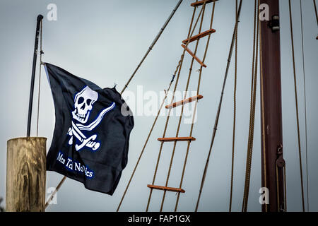 skull and crossbones flag flying on ship mast closeup. Kids tour ride in Murrels Inlet, South Carolina Stock Photo