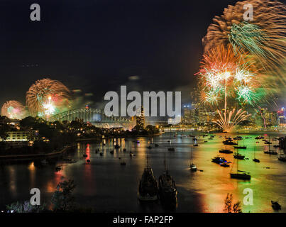 Wide view over Berrys bay of Sydney harbour on New Year night during NYE celebration fireworks highlighting CBD and Harbour Stock Photo