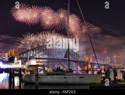 New Year holiday fireworks in SYdney over Harbour Bridge at midnight as seen from Lavender Bay over CBD landmarks Stock Photo
