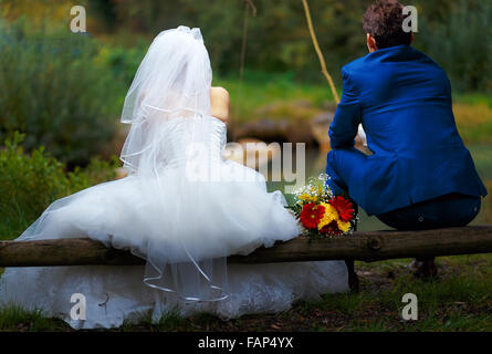 bride and groom fishing together - romantic wedding concept Stock Photo