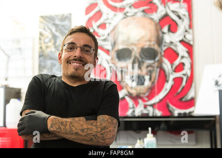 Aesch, Switzerland. 14th Aug, 2015. Dennis Weber, a man with dwarfism, poses in a tattoo studio in Aesch, Switzerland, 14 August 2015. Many people with dwarfism face problems when looking for a job. Photo: PATRICK SEEGER/dpa/Alamy Live News Stock Photo