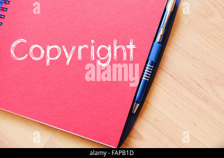 Copyright text concept write on notebook with pen Stock Photo