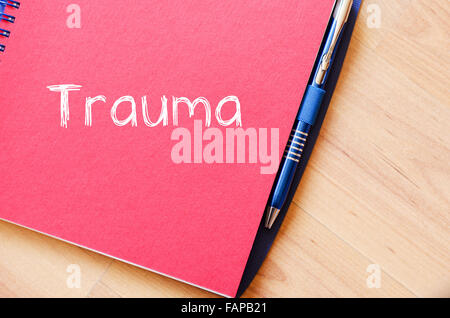 Trauma text concept write on notebook with pen Stock Photo