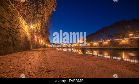 Autumn leaves on embankment of Tiber River in Rome, Italy Stock Photo