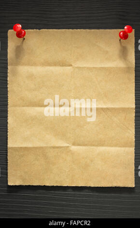 folded note paper on wooden background Stock Photo