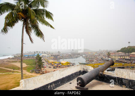 Canons overlooking the old slavery town of Cape Coast in Ghana from the clave fort. Stock Photo