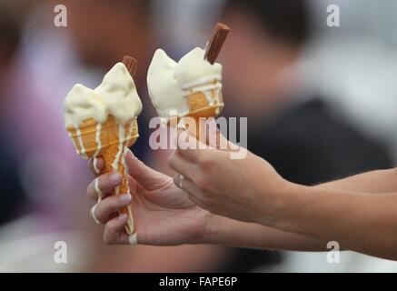 Two Melting ice creams in cones on a hot summers day. Stock Photo