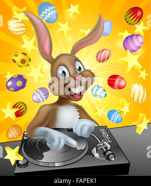Cartoon Easter bunny DJ playing music at the the decks or turn tables with chocolate Easter eggs in the background Stock Photo