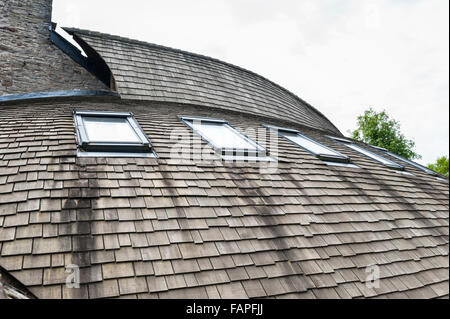 Herefordshire, UK. A self built house, timber clad, with a curved roof covered with wooden cedar shingles Stock Photo