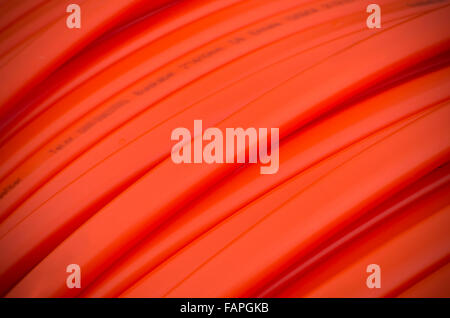 closeup of orange fiber cable on a construction site Stock Photo