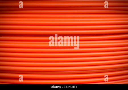 closeup of orange fiber cable on a construction site Stock Photo