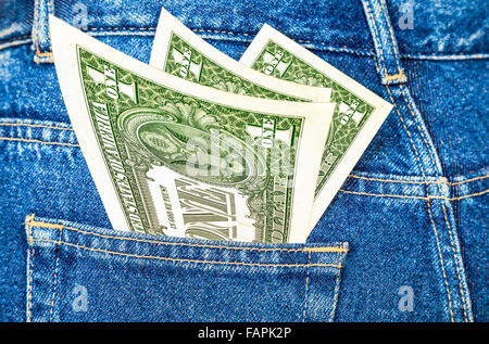 Banknotes of one american dollar sticking out of the back jeans pocket Stock Photo