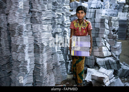 Jan. 3, 2016 - Dhaka, Bangladesh - ZAHID is 13 year old boy who joined in bookbinding factory 6 months ago. He earns less than 40 USD per month. His family lives in village where his father works as a day labor..Child labor is very common in almost every industry of Bangladesh such as Aluminum factory, Balloon factory, Ship Building industry and Book binding factory. The main reason of this child labor is poverty and lowest rate of wage. Lower wage keeps child labor in loop. There is no statistics available to determine exact ratio of adults and children working in such factories; but it seems Stock Photo
