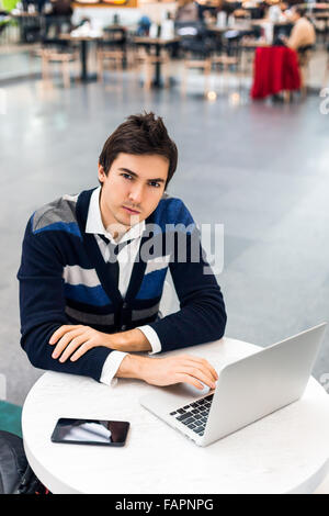 Handsome freelancer thinking seriously while work Stock Photo