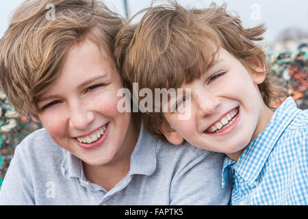 Outdoor portrait photograph of young happy boy children brothers smiling together Stock Photo