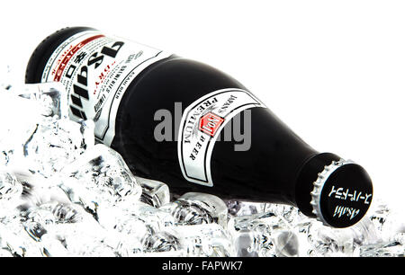 Bottle of  Asahi Super Dry Beer on ice over a white background Stock Photo