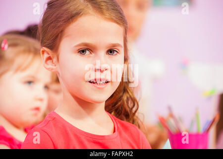 Close portrait of little girl with few other kids Stock Photo