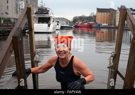 Helsinki. Katajanokka Guest Harbour Pier north of Katajanokka, Helsinki, Finland. An elderly lady out of the water after a sauna Stock Photo