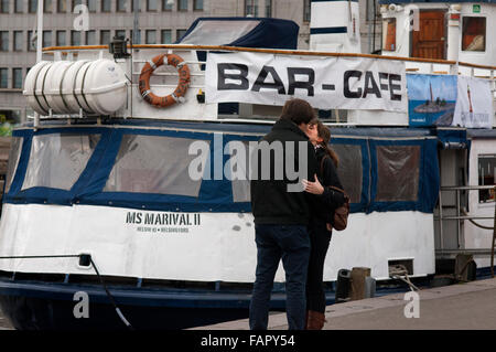 A couple kiss near the cruise terminal at Kauppatori, Helsinki, Finland.  The Port of Helsinki is divided into two areas. West H Stock Photo