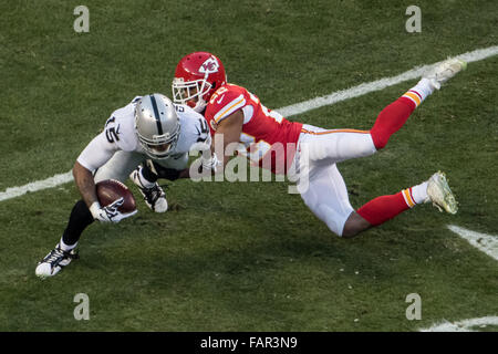 Oakland Raiders wide receiver Michael Crabtree (15) catches a pass in front  of Denver Broncos cornerback Bradley Roby (29) during the first half of an NFL  football game in Oakland, Calif., Sunday