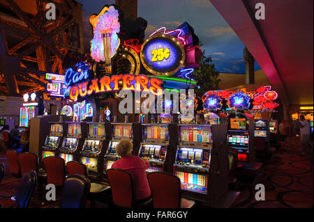 Elderly woman playing a slot machine in the casino of the Paris Hotel, Las Vegas, Nevada. Stock Photo