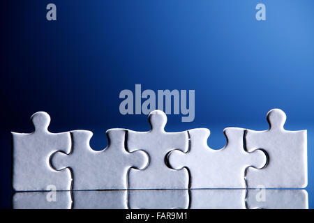 Five puzzle pieces arranged together. Stock Photo