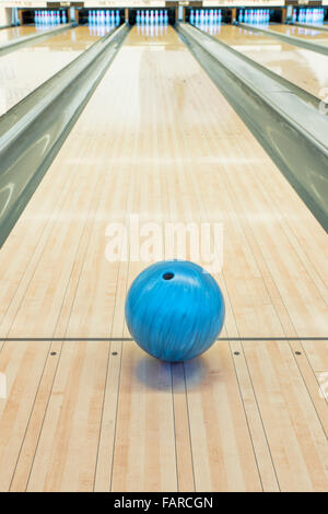Balls on bowling alley against ten pins Stock Photo