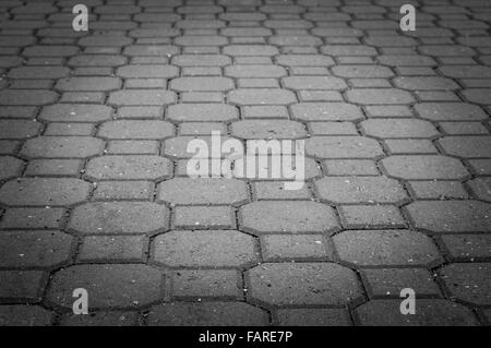 Grey tiles urban pavement background, image vignetting and black and white tones Stock Photo