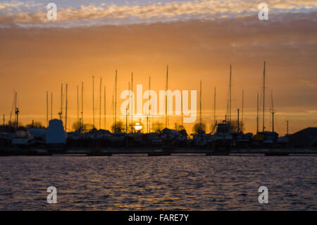 Blurred image of sunset in yacht harbor with mast silhouettes Stock Photo