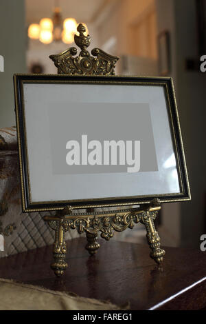 Picture gold frame with a decorative pattern and stand. Stock Photo