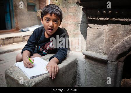 Child drawing on the street. Kathmandu. Nepal. Stock Photo