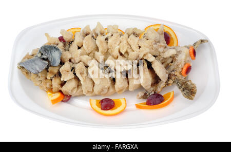 Fried New Year carp fish in Chinese style lie on plastic thermo plate. Isolated with patch Stock Photo